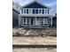 Two-story navy home features white trim, modern windows, and a welcoming front porch at 617 W 39Th St, Indianapolis, IN 46208