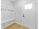 Bright mudroom with coat hooks and a storage bench by the front door at 617 W 39Th St, Indianapolis, IN 46208