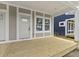 Spacious porch with a wood deck and view of the adjacent blue house at 617 W 39Th St, Indianapolis, IN 46208