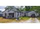 A well-maintained home with a manicured yard and attached one car garage at 618 S Tibbs Ave, Indianapolis, IN 46241
