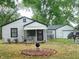 A well-maintained home boasting a manicured front yard and a one car garage at 618 S Tibbs Ave, Indianapolis, IN 46241