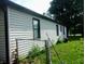 A home featuring a chain link fence with lush green grass at 618 S Tibbs Ave, Indianapolis, IN 46241