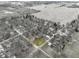 High angle perspective showing a rural neighborhood surrounded by agricultural fields and interspersed with trees at 6201 S Carroll Rd, Indianapolis, IN 46259