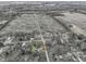 Overhead angle of a home and neighborhood with a large field in the background and multiple residences in the area at 6201 S Carroll Rd, Indianapolis, IN 46259
