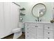Modern bathroom featuring a white vanity, round mirror, and clean lines, offering a fresh and contemporary feel at 6201 S Carroll Rd, Indianapolis, IN 46259