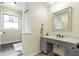 This bathroom has tile floors, a framed mirror, and a vanity with marble countertop at 6201 S Carroll Rd, Indianapolis, IN 46259