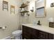 Stylish half bathroom with a dark wood vanity, modern fixtures, and decorative shelving, offering a touch of elegance at 6201 S Carroll Rd, Indianapolis, IN 46259