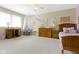 This carpeted bedroom has a window, a white canopy, a desk, and a wooden bed with a patterned comforter at 6201 S Carroll Rd, Indianapolis, IN 46259