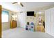 This carpeted bedroom has nautical themed decor, a ceiling fan, a dresser, and an open doorway at 6201 S Carroll Rd, Indianapolis, IN 46259