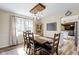 Bright dining room has an open floor plan with a wooden table, decorative chandelier, and views of the living room at 6201 S Carroll Rd, Indianapolis, IN 46259