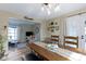 Inviting dining room features wood floors, a rustic table, and natural light, creating a warm and welcoming atmosphere at 6201 S Carroll Rd, Indianapolis, IN 46259