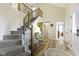 Elegant foyer showcasing hardwood floors and a staircase leading to the upper level at 6201 S Carroll Rd, Indianapolis, IN 46259