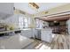 Bright kitchen features white cabinets, farmhouse sink, stainless steel appliances, and an island open to the living room at 6201 S Carroll Rd, Indianapolis, IN 46259