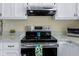 Modern stainless steel oven range complementing the white cabinetry in this bright kitchen at 6201 S Carroll Rd, Indianapolis, IN 46259