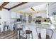 Well-lit kitchen with white cabinets, stainless steel appliances, and a breakfast bar at 6201 S Carroll Rd, Indianapolis, IN 46259