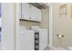 Practical laundry area featuring a washer, dryer, and storage, maximizing space with overhead cabinets at 6201 S Carroll Rd, Indianapolis, IN 46259