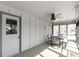 Bright sunroom with an outdoor dining set, carpeted floors, and view of the fenced backyard at 6201 S Carroll Rd, Indianapolis, IN 46259