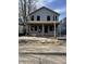 New home in framing stage showing unfinished siding and covered front porch under a bright blue sky at 621 W 39Th St, Indianapolis, IN 46208