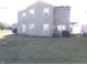 Backyard of a two-story house with a lawn, patio, and a sliding glass door at 6651 Sonesta Dr, Indianapolis, IN 46217