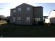 View of the home's rear facade with tidy back lawn area, patio, and tidy vinyl siding at 6651 Sonesta Dr, Indianapolis, IN 46217