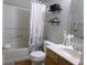 Cozy bathroom with a shower and tub combination and floral curtains that add a beautiful accent at 6651 Sonesta Dr, Indianapolis, IN 46217