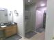 Well-lit bathroom featuring a double sink vanity and a glass-enclosed shower at 6651 Sonesta Dr, Indianapolis, IN 46217