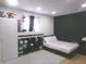 A modern bedroom with a dark accent wall, sleek furniture, and carpeted floors at 6651 Sonesta Dr, Indianapolis, IN 46217