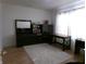 Bright bedroom featuring a large window and a cozy shag rug on a wood floor at 6651 Sonesta Dr, Indianapolis, IN 46217
