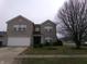 Charming two-story brick home with an attached garage and well-maintained landscaping and healthy trees at 6651 Sonesta Dr, Indianapolis, IN 46217