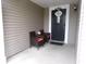 Inviting front porch with wicker seating and a decorative 'Bless This Home' door decor at 6651 Sonesta Dr, Indianapolis, IN 46217