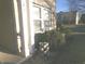 Front exterior featuring lush green bushes and decorative stacked potted plants near the house entrance at 6651 Sonesta Dr, Indianapolis, IN 46217