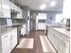 Bright kitchen with white cabinets, stainless steel appliances, and hardwood floors at 6651 Sonesta Dr, Indianapolis, IN 46217