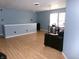 Spacious living room with hardwood floors, a comfortable sofa and a desk offering a versatile living space at 6651 Sonesta Dr, Indianapolis, IN 46217