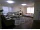 Comfortable living room featuring a large gray sofa, fireplace, and modern decor at 6651 Sonesta Dr, Indianapolis, IN 46217
