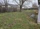 Large fenced backyard with grass and a mature shade tree at 7128 Moon Ct, Indianapolis, IN 46241