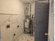 Small laundry room features a water heater and storage shelf at 7128 Moon Ct, Indianapolis, IN 46241