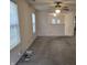 Spacious living room with multiple windows, ceiling fan, and carpet flooring at 7128 Moon Ct, Indianapolis, IN 46241