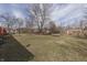 Expansive backyard with ample space, mature trees, and trampoline, offering an idyllic outdoor setting at 7602 E 34Th Pl, Indianapolis, IN 46226
