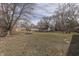 Spacious backyard with mature trees and trampoline; a perfect outdoor retreat for relaxation and play at 7602 E 34Th Pl, Indianapolis, IN 46226