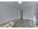 Spacious bedroom features wood-look floors, closet, and fresh paint at 7602 E 34Th Pl, Indianapolis, IN 46226