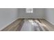 Small bedroom features wood-look floors and fresh paint at 7602 E 34Th Pl, Indianapolis, IN 46226
