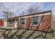 Low angle view of the home's front exterior with a classic red brick exterior at 7602 E 34Th Pl, Indianapolis, IN 46226