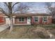 Charming brick ranch home with a well-maintained front yard and classic architectural details at 7602 E 34Th Pl, Indianapolis, IN 46226