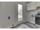 Kitchen features an exterior door, stainless steel appliances, and wood-look floors at 7602 E 34Th Pl, Indianapolis, IN 46226
