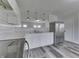 Modern kitchen featuring stainless steel refrigerator, marble countertops and stylish subway tile backsplash at 7602 E 34Th Pl, Indianapolis, IN 46226