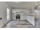Bright and airy eat-in kitchen with stainless steel appliances, white cabinets, and modern fixtures at 7602 E 34Th Pl, Indianapolis, IN 46226