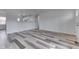 Spacious living room with open layout, stylish floors, and a clear view into the kitchen at 7602 E 34Th Pl, Indianapolis, IN 46226
