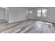 Living room showcasing the sleek floors, natural light, and freshly painted walls at 7602 E 34Th Pl, Indianapolis, IN 46226
