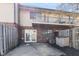 Charming townhouse backyard featuring a brick facade, balcony, and concrete patio, offering a private outdoor space at 8 Greenwood Trail S Dr, Greenwood, IN 46142