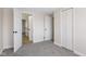 Bedroom with plush carpets has a closet and an entrance to another room at 8 Greenwood Trail S Dr, Greenwood, IN 46142